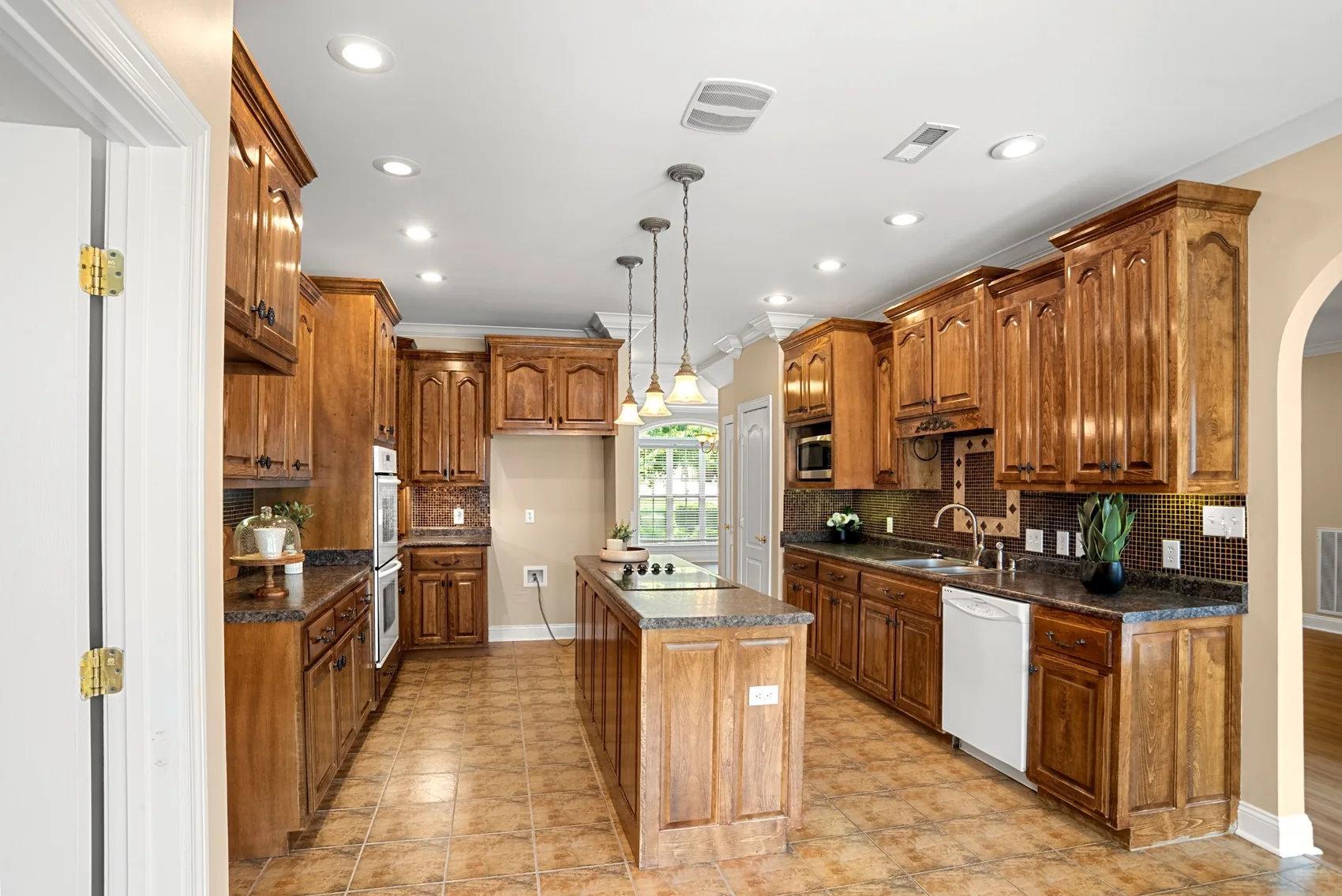 Spacious kitchen with wood cabinetry and center island